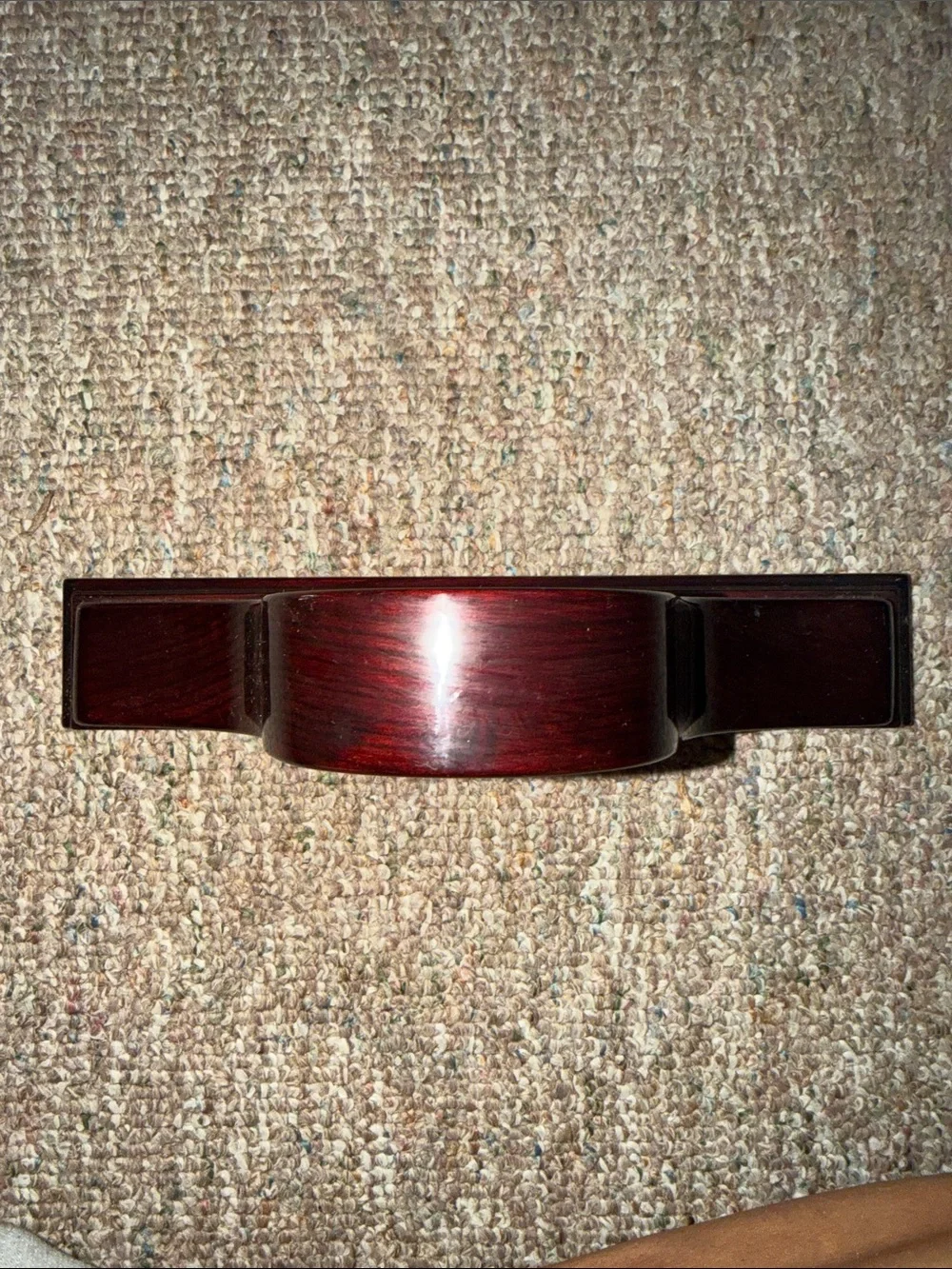 empty, polished wooden mantel clock case with a traditional arched profile